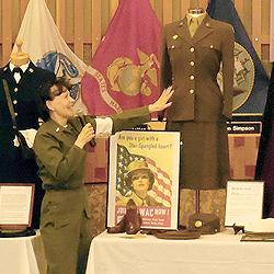 Alice, dressed as a Korean War-era nurse, shows off a WAC (Women's Army Corps) uniform from World War II.